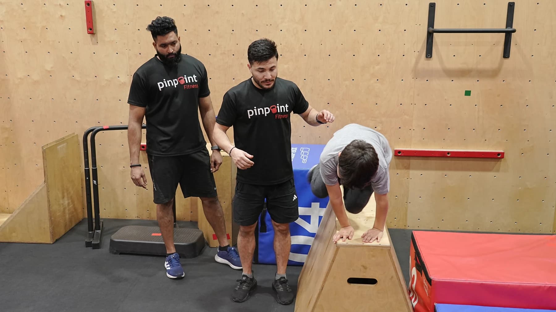 A child focused on an obstacle course challenge at Pinpoint Fitness